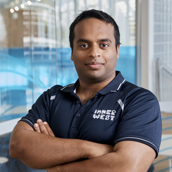 Personal trainer Shanil Patwary smiling with arms crossed in front of chest